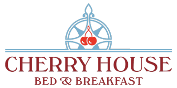 Logo for Cherry House Bed & Breakfast featuring a compass design and stylized text.